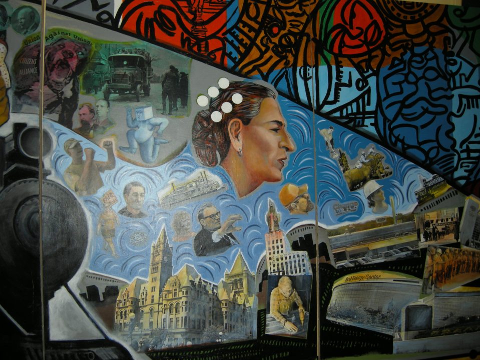 a painted mural depicting local figures and locations